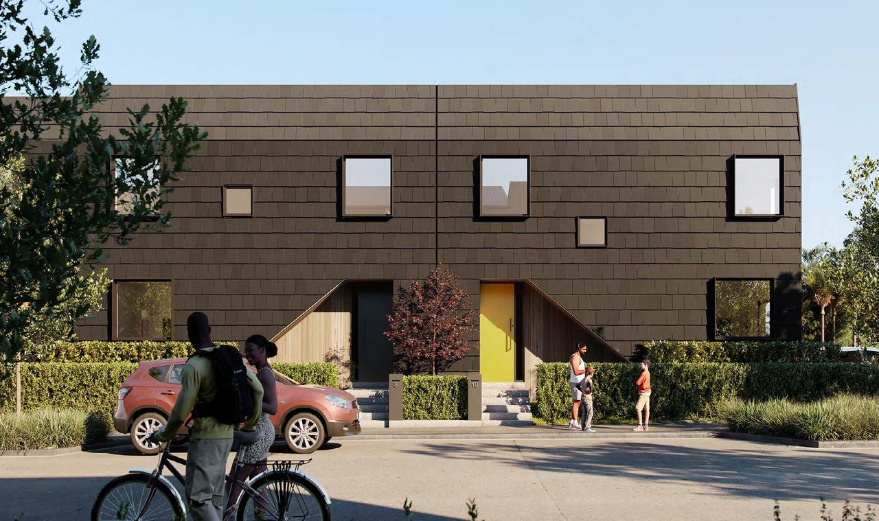 Looking across the street at the other smaller block in the development; the tiles are dark grey and one of the units has a cheerful yellow front door. 