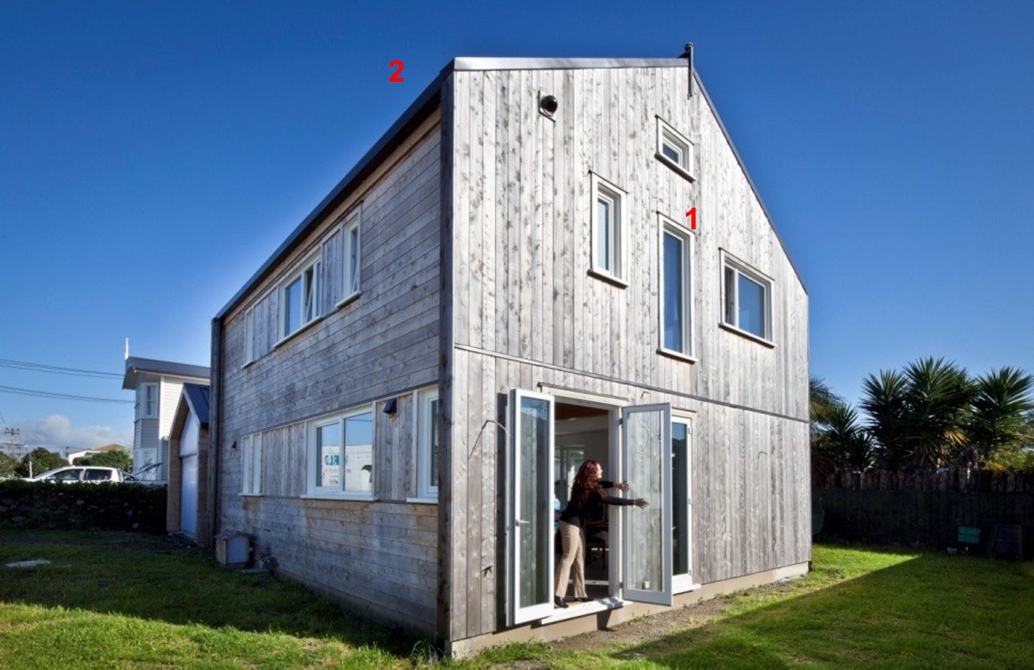 Side perspective of the house, owner opening the side door.