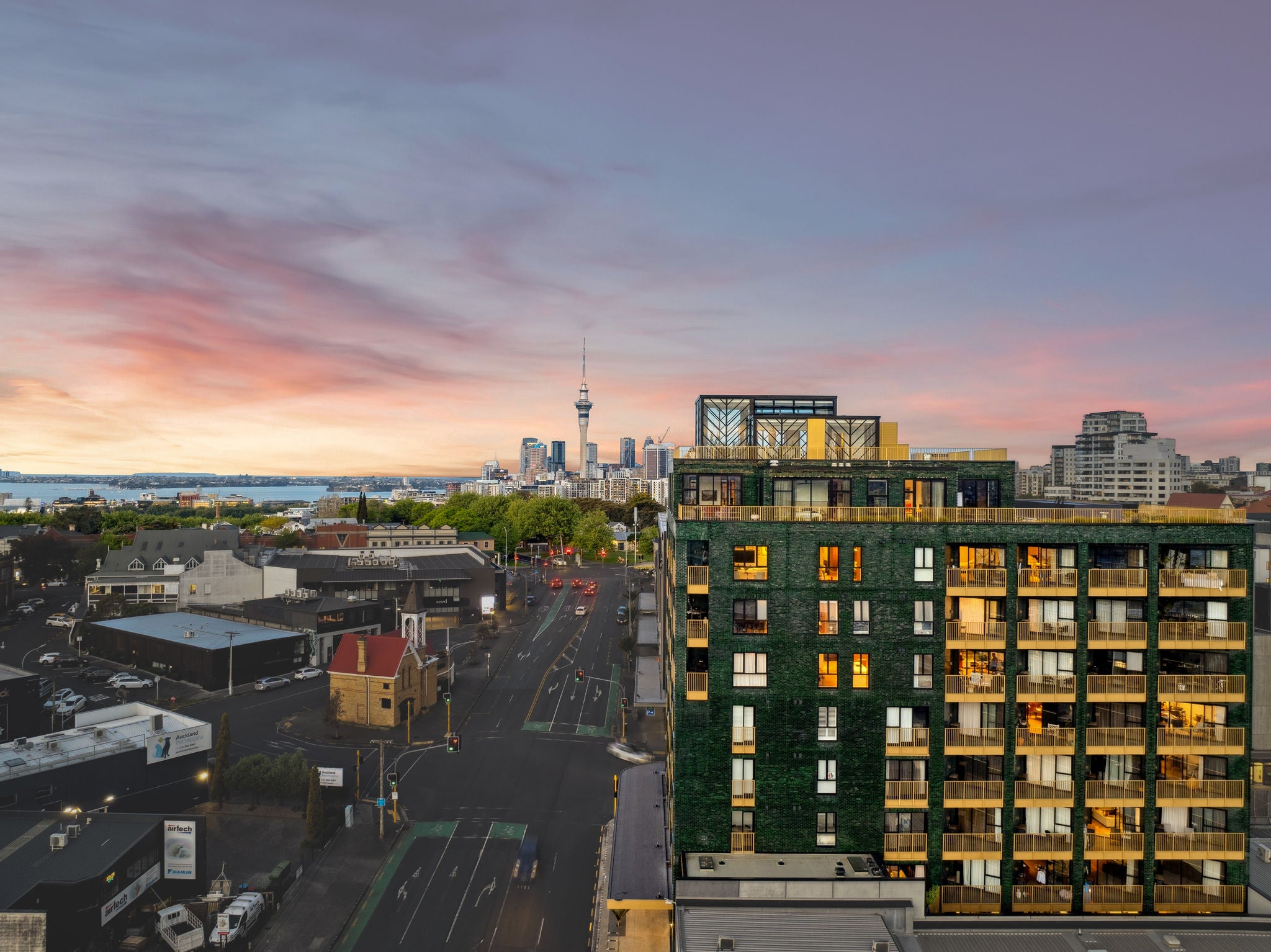 City scape featuring The Greenhouse apartments, side profile including the Skytower in the background. Image - Ockham Residential 