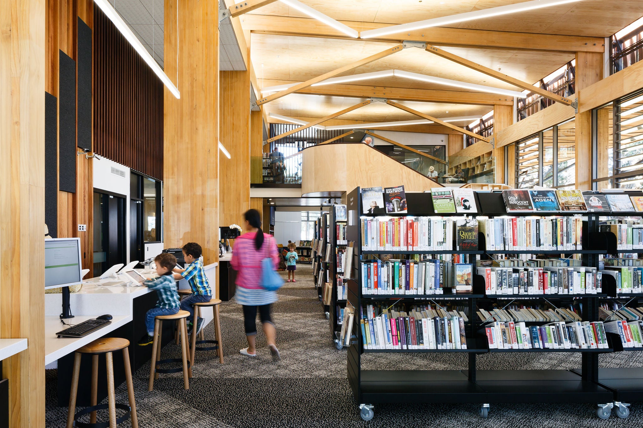 Kids are using the facilities as a woman walks by.