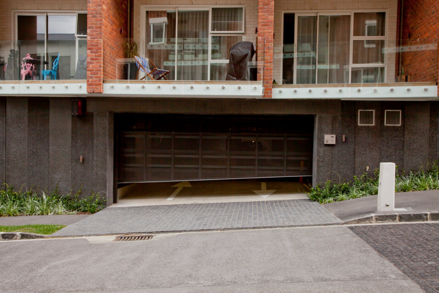 Looking across the street at the garage basement door as it opens to the street.