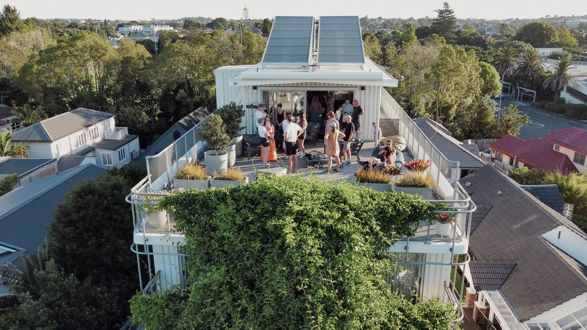 Shared rooftop from an aerial perspective with people chatting and chilling.