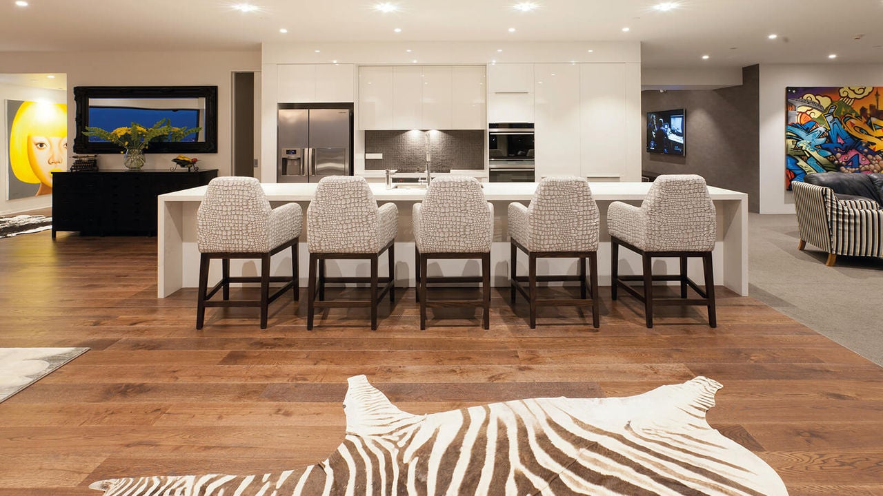 Large kitchen bench with enough space for 5 large barstools . Open space flow through to the lounge and more.