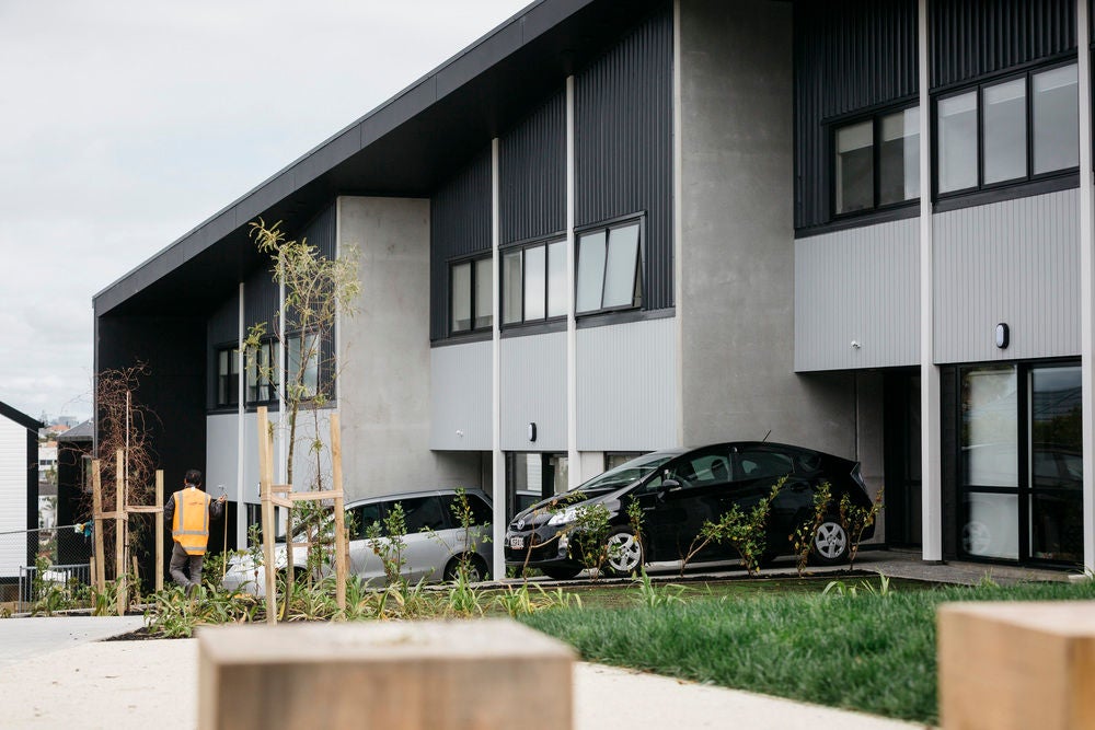 Two storey terraced dwellings with central courtyard area in front, that are part of an urban papakāinga located on Kupe Street, Ōrākei, Auckland, ancestral whenua of Ngāti Whātua Ōrākei.  