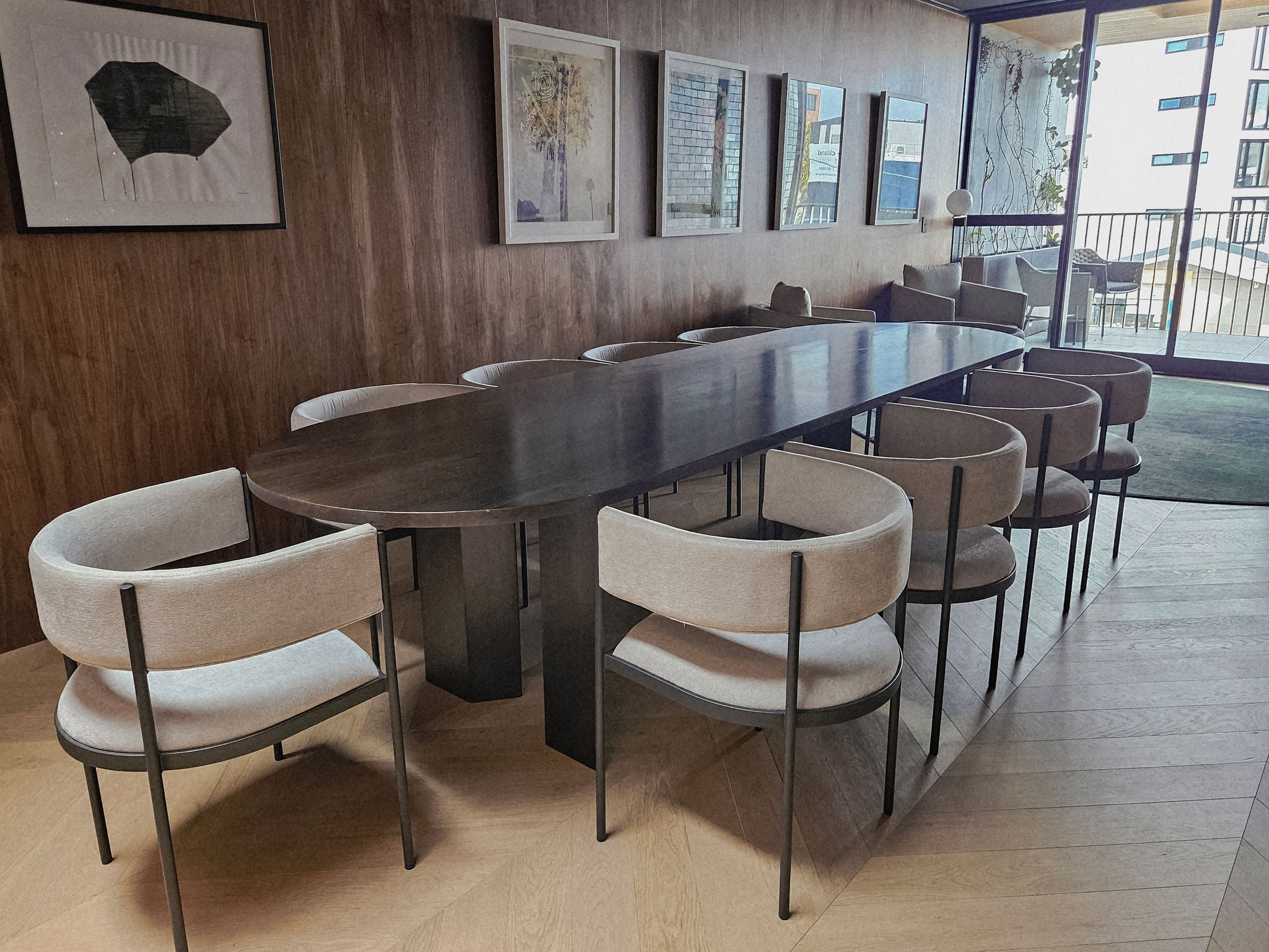 Showing the shared communal lounge with 10 chairs, looking over to the balcony.