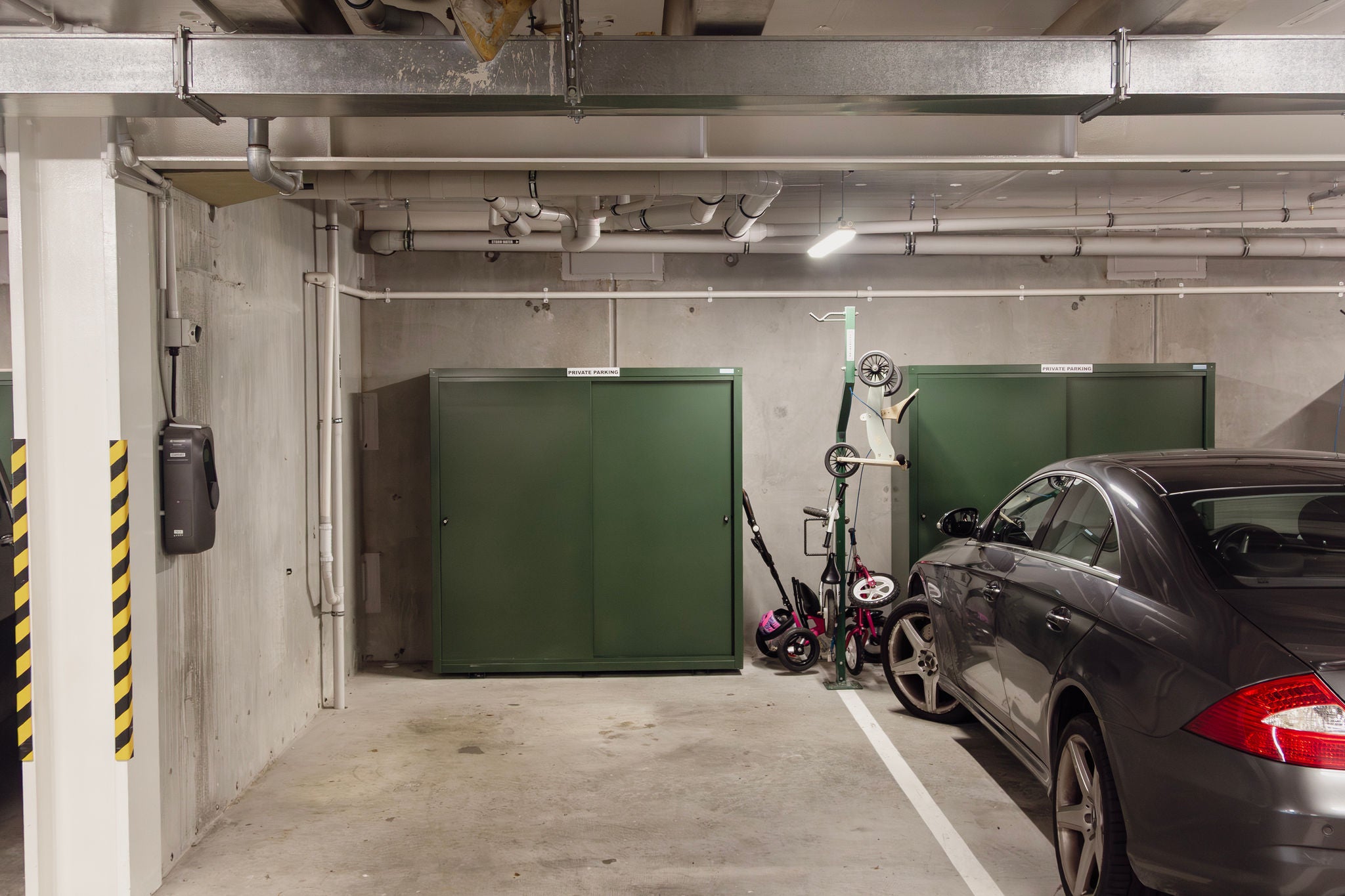 Basement carpark space includes storage and bike parking tree.