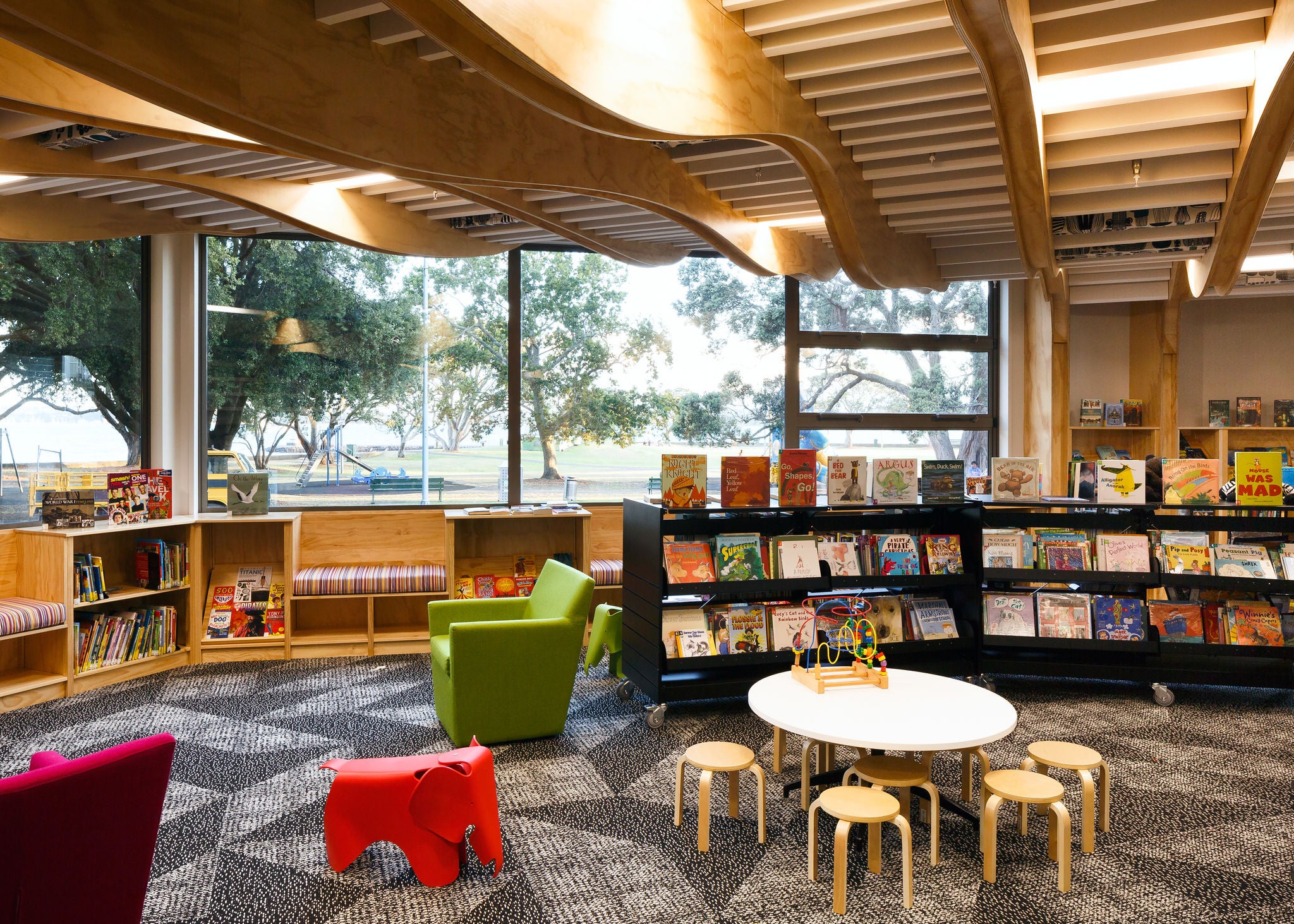 Inside the kids area, cute small furniture, toys and books are visible.
