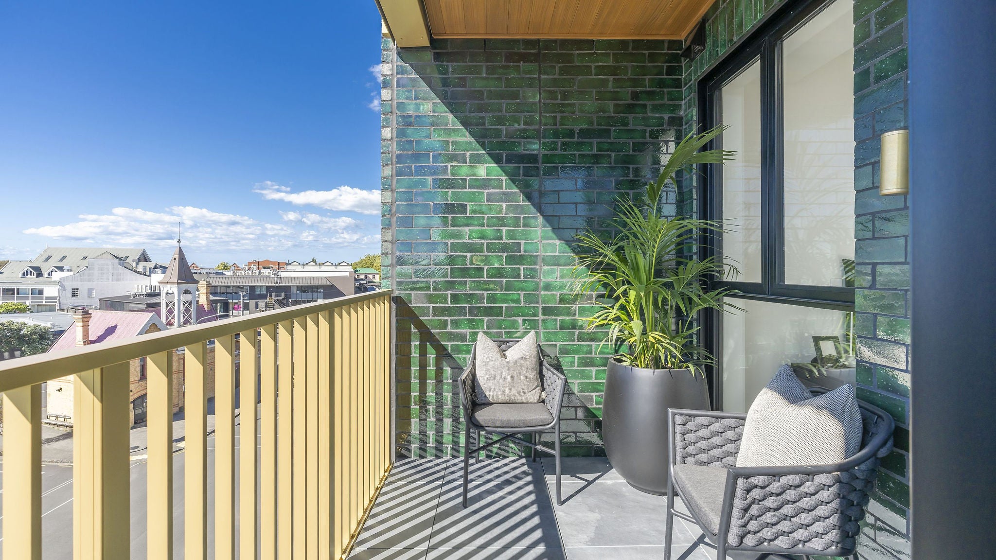 2 chairs and a plant adorn the upper balcony with a nice view over Ponsonby.