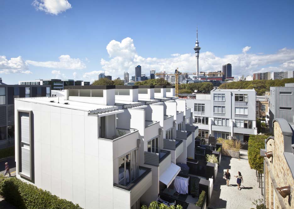 On a sunny day looking down on the apartments and terraces with the Auckland skyline in the background.