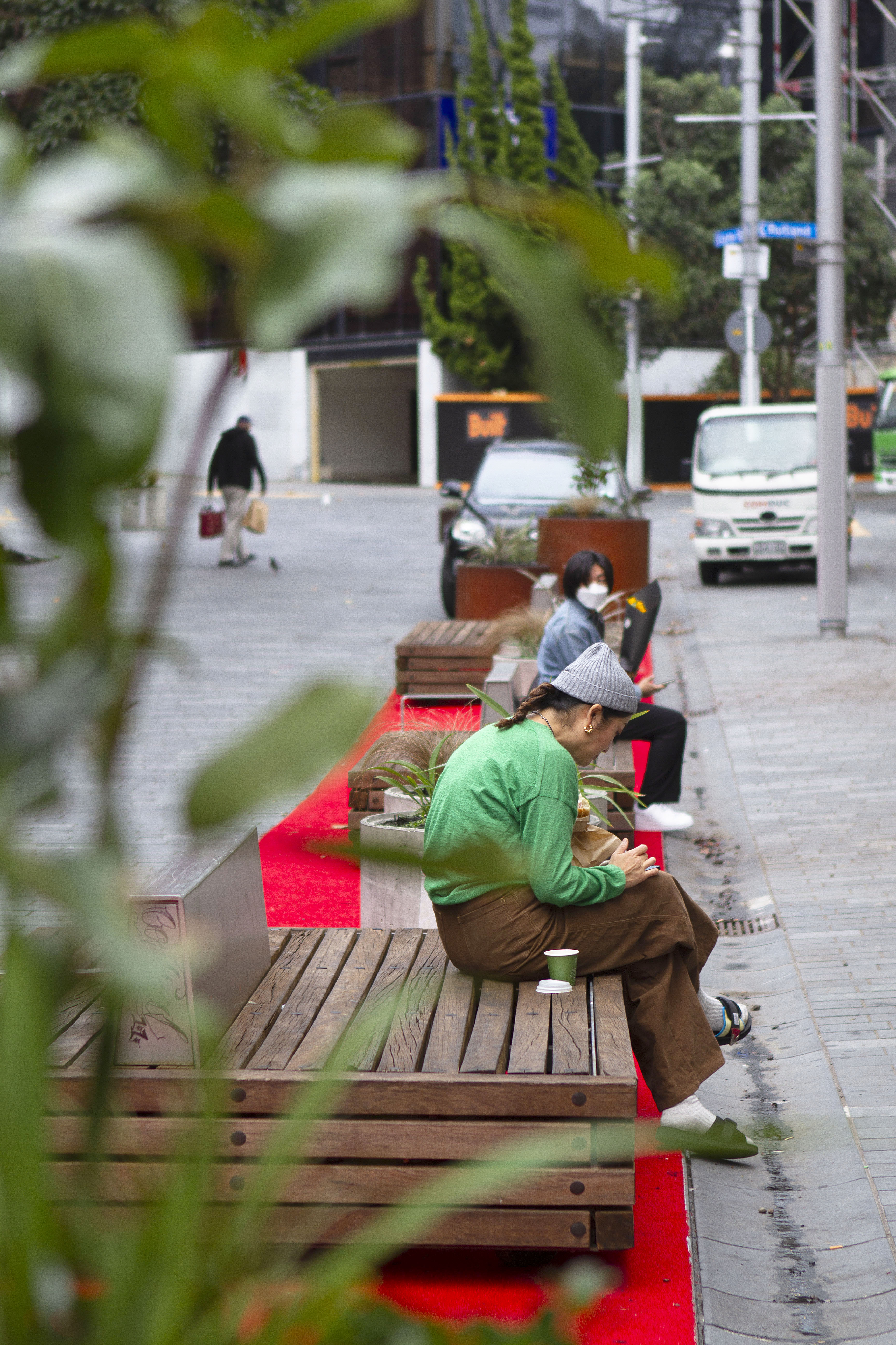 Lorne St traffic calming with red carpet, benches and planters outside Auckland Library