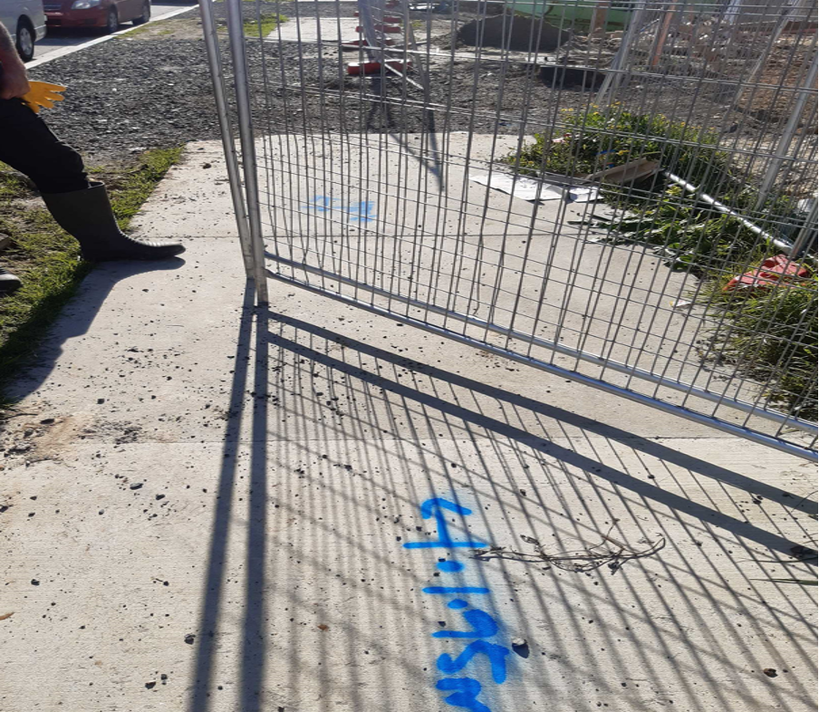 Markings on the pavement showing where the pipe is.